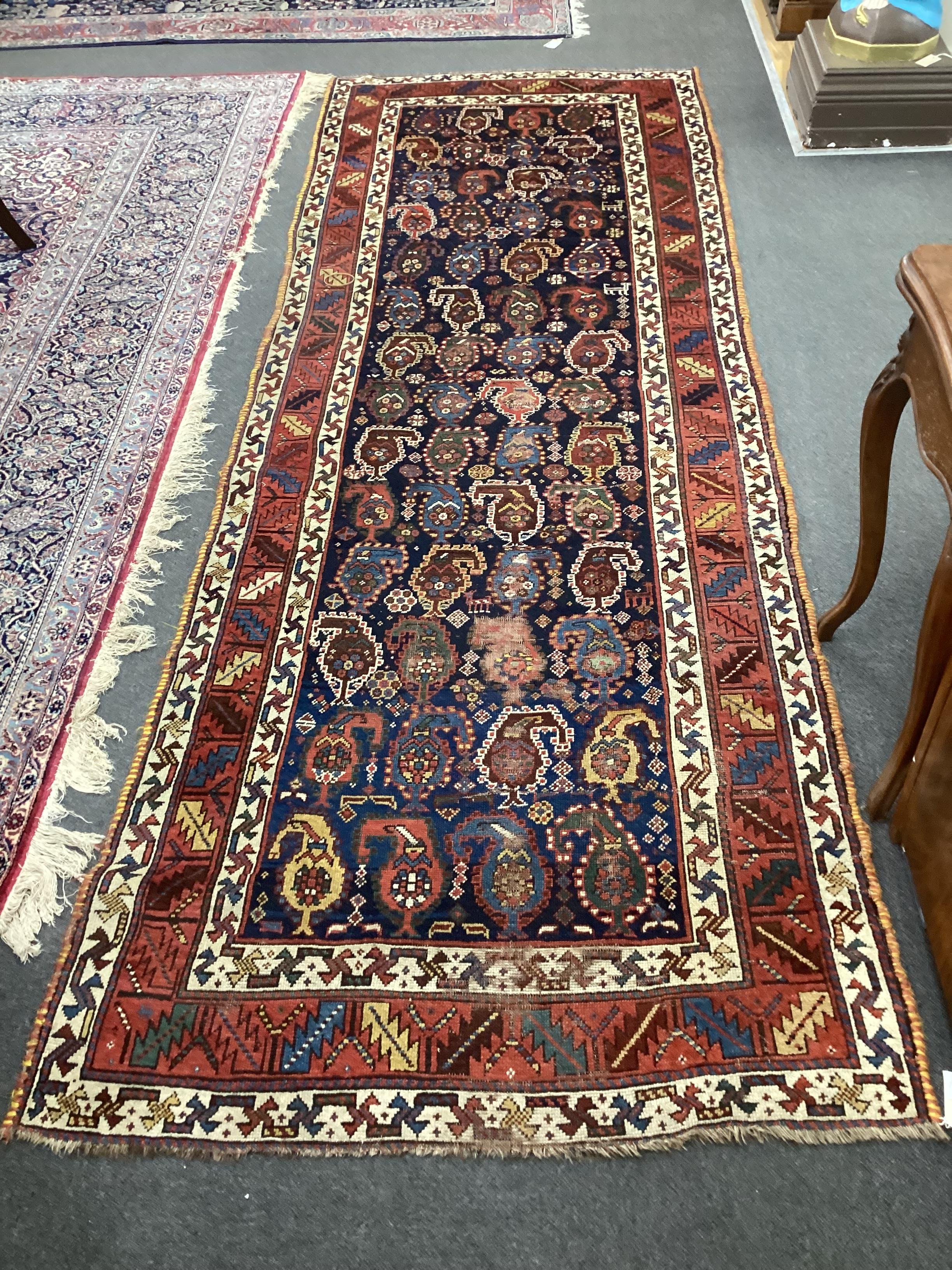 A Caucasian Karabagh runner, the dark indigo field woven with rows of botehs, 330 x 116cm